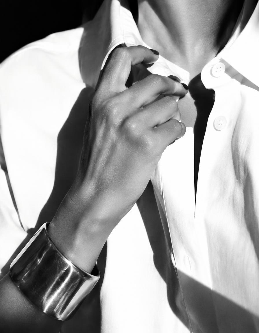 Detail: gold cuff on a white shirt collar
